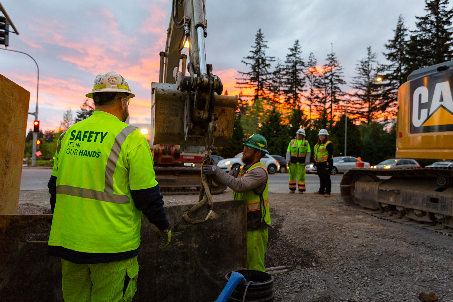 Men in safety vests and protective gear at construction site